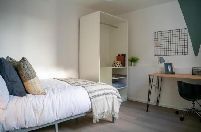 A bright and tidy double bedroom featuring a co...