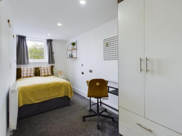 A bright and inviting double bedroom featuring ...
