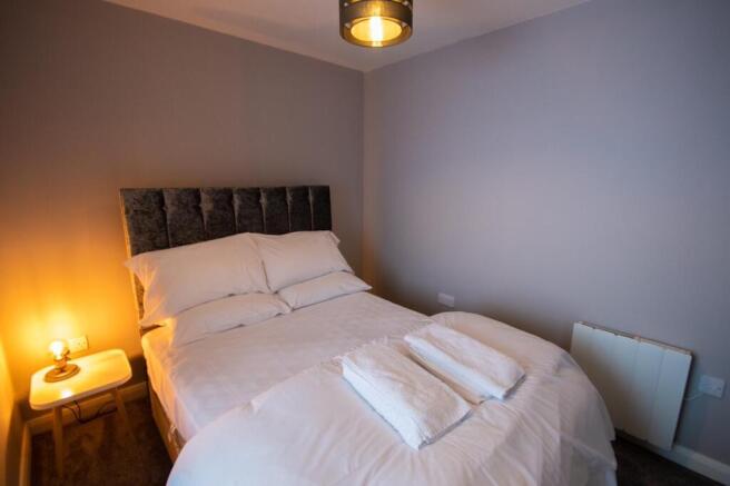 A stylish and inviting double bedroom with comf...