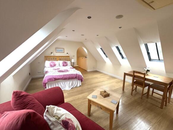 A bright and spacious double bedroom featuring ...