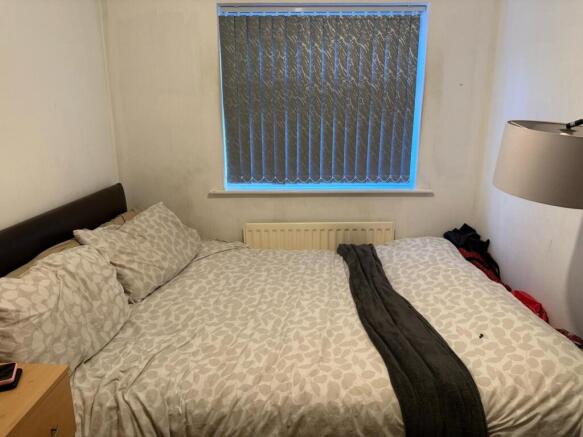 Cozy double bedroom featuring a comfortable bed...