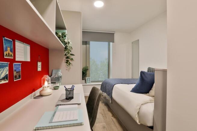 A cozy double bedroom featuring a comfortable b...