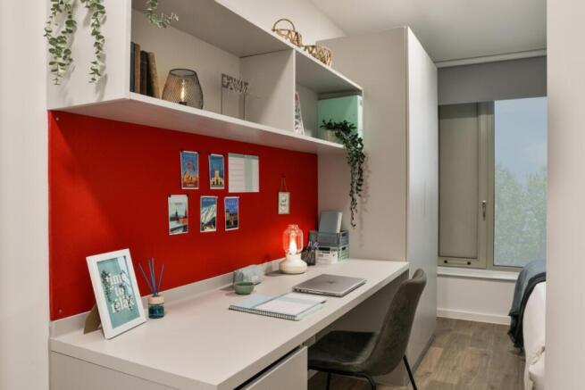 A stylish double bedroom featuring a vibrant re...
