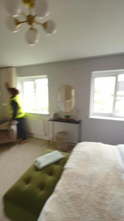 A charming double bedroom featuring natural lig...