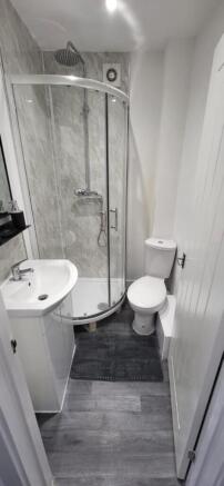 This stylish bathroom features a modern shower ...