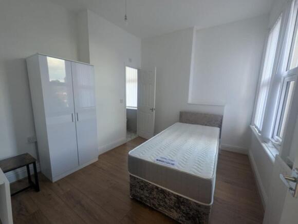 Bright and spacious double bedroom featuring a ...