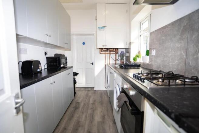 This modern kitchen features sleek cabinetry an...