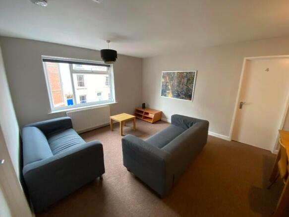 Bright and inviting living room featuring comfo...