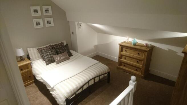 This charming double bedroom features a cozy la...