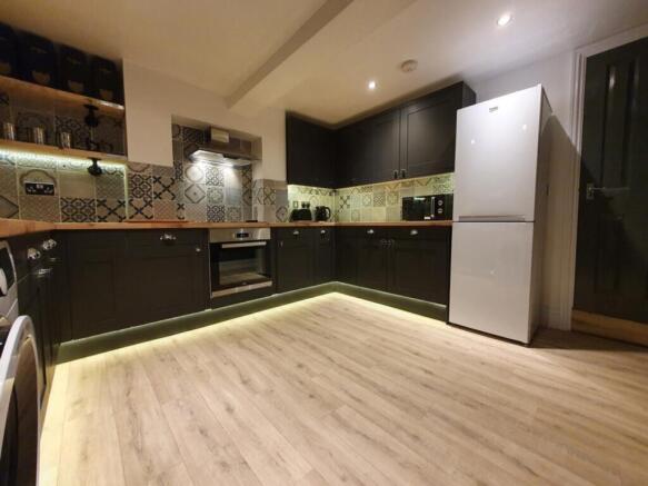 A modern kitchen featuring stylish cabinetry, a...