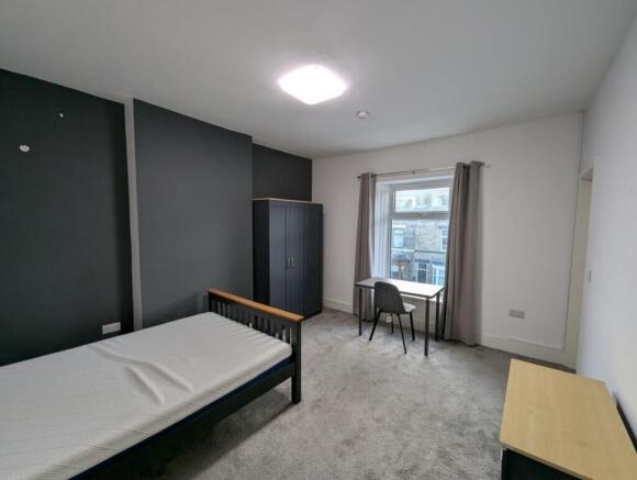 Spacious double bedroom featuring a comfortable...
