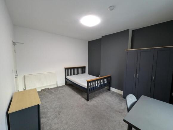 A stylish double bedroom featuring a modern des...