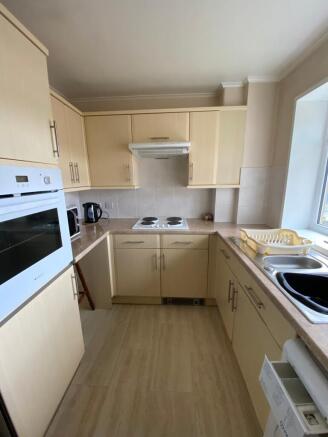 This modern kitchen features ample cabinetry, a...