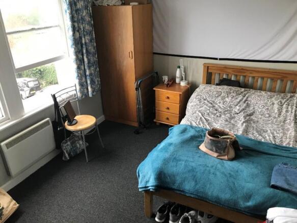 This cozy double bedroom features a comfortable...