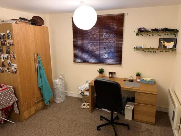 A cozy double bedroom featuring a comfortable d...