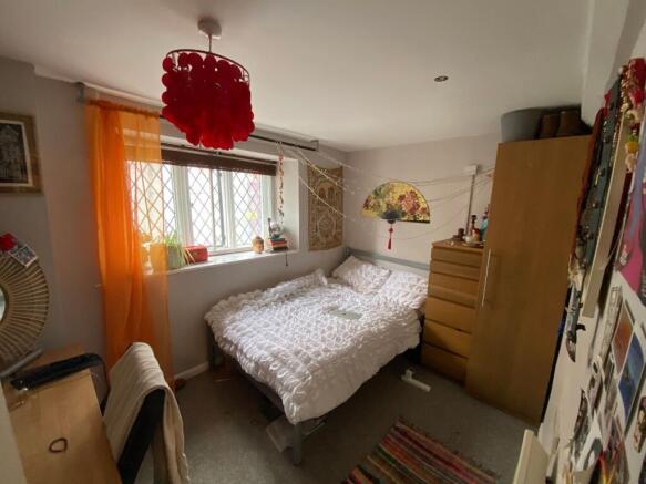 Cozy double bedroom featuring a comfortable bed...