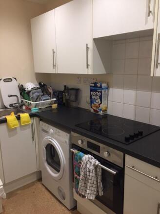 A compact kitchen featuring essential appliance...