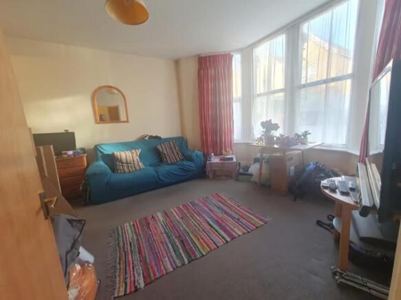 Bright and inviting living room featuring large...