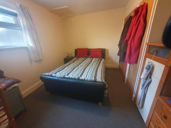 Cozy double bedroom featuring a comfortable bed...
