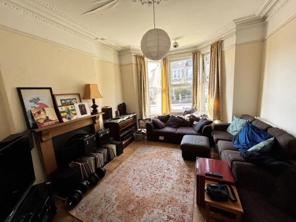 A cozy living room featuring ample natural ligh...
