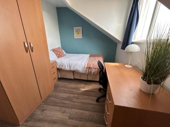 Cozy double bedroom featuring a comfortable bed...