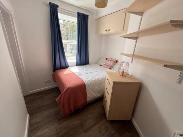 Cozy double bedroom featuring ample natural lig...
