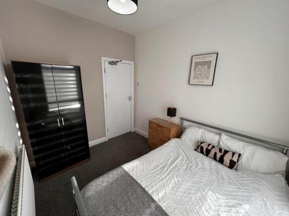 A cozy double bedroom featuring a comfortable b...