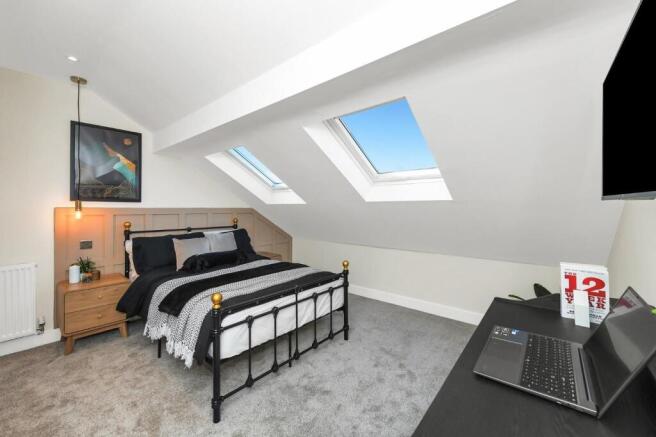 This charming double bedroom features a cozy at...