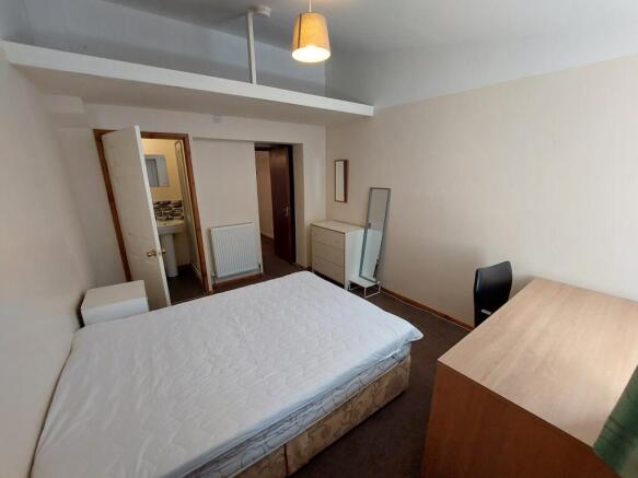 Spacious double bedroom featuring ample natural...