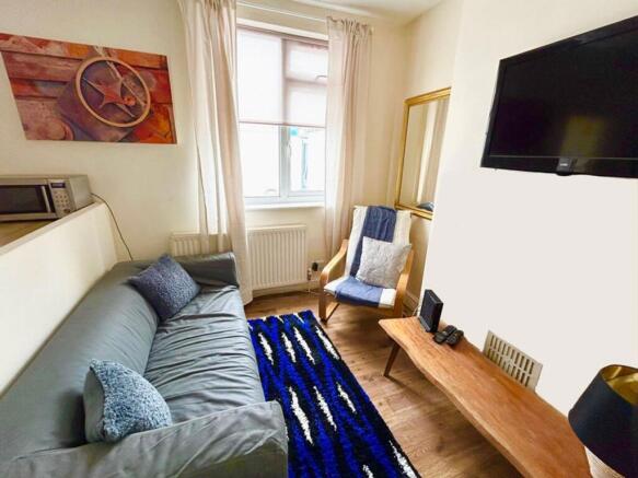 This inviting living room features a cozy sofa,...
