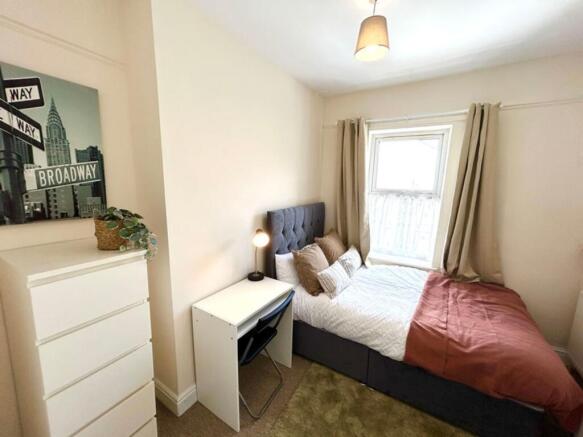 This charming double bedroom features a cozy la...