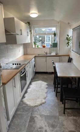 A bright and modern kitchen featuring sleek cab...