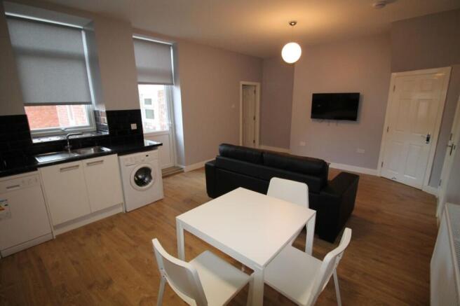 Bright and modern living room featuring a styli...