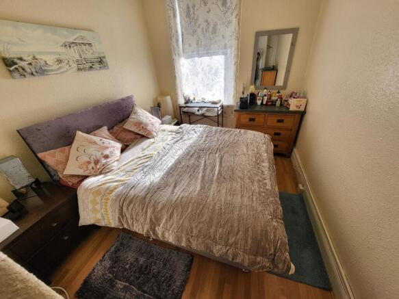 Cozy double bedroom featuring ample natural lig...