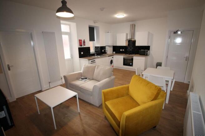 Spacious living room featuring comfortable seat...