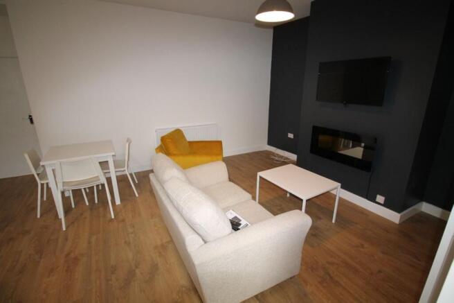 This stylish living room offers a cozy atmosphe...