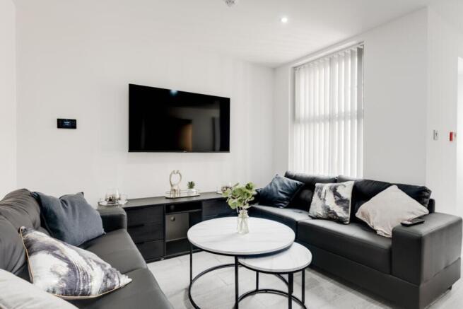 A bright and inviting large modern living room ...