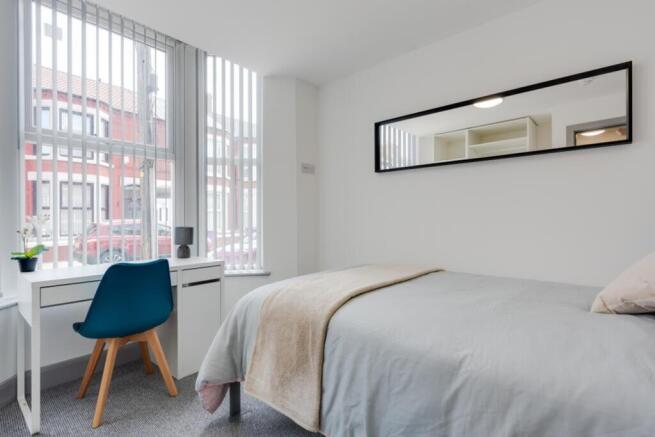 A bright and inviting double bedroom featuring ...