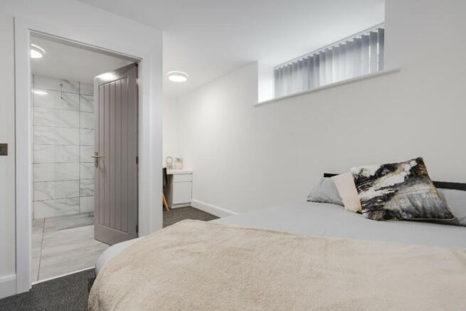 A stylish double bedroom featuring modern decor...