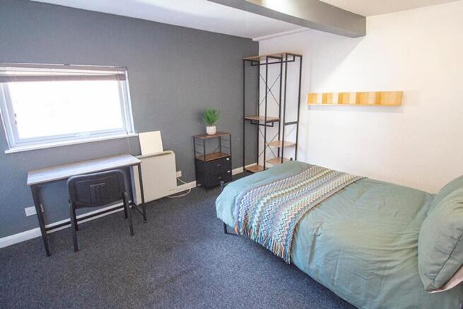 Bright and inviting double bedroom featuring a ...