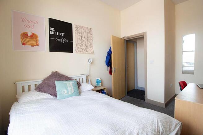 This cozy double bedroom features stylish decor...