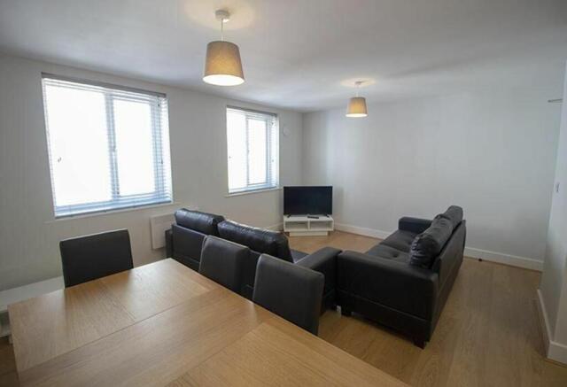 Bright and spacious living room featuring comfo...