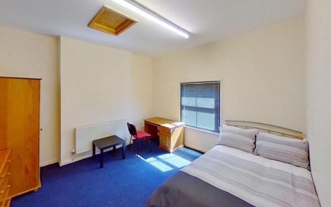 This inviting double bedroom features ample nat...