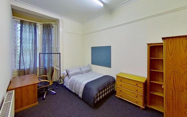 Spacious and inviting double bedroom featuring ...