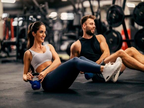 A vibrant gym space featuring individuals engag...