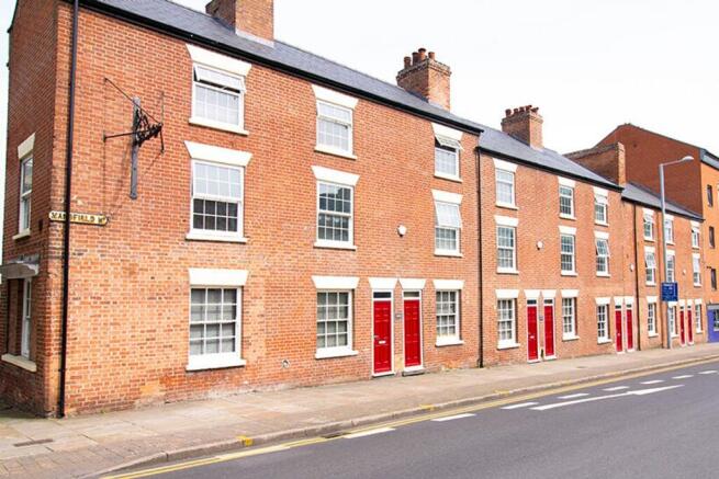 Charming red-bricked exterior featuring a serie...