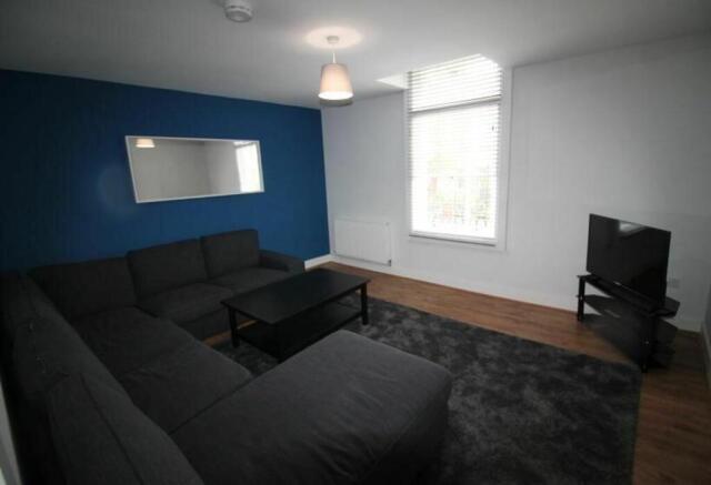 Spacious and inviting living room featuring a m...