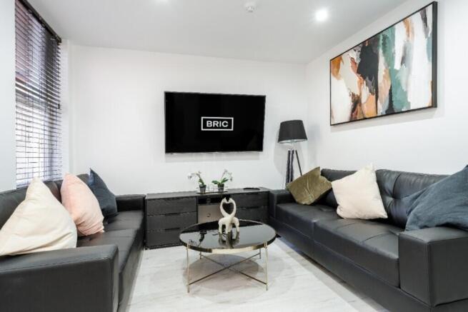 A stylish and modern living room featuring plus...