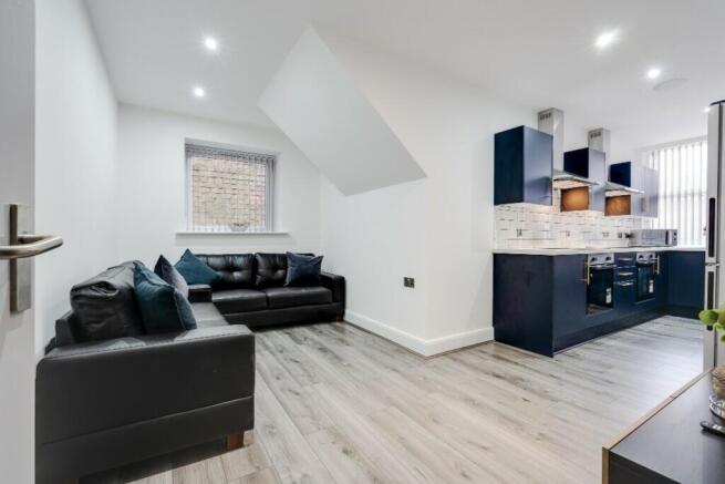 A stylish and modern living room featuring a co...