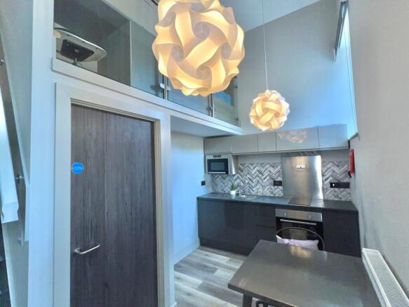 Stylish and modern kitchen featuring sleek cabi...